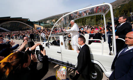 Pope Francis waves to the faithful as he arrives in San Giovanni Rotondo, Italy March 17, 2018. REUTERS/Tony Gentile