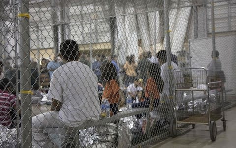 People detained by US Border Patrol agents at the Central Processing Center in McAllen - Credit: AFP