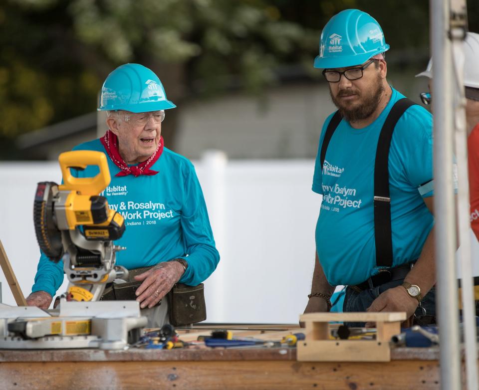 President Jimmy Carter at a work table with another volunteer at a Habitat for Humanity build in Mishawaka, Tuesday, Aug. 28, 2018.