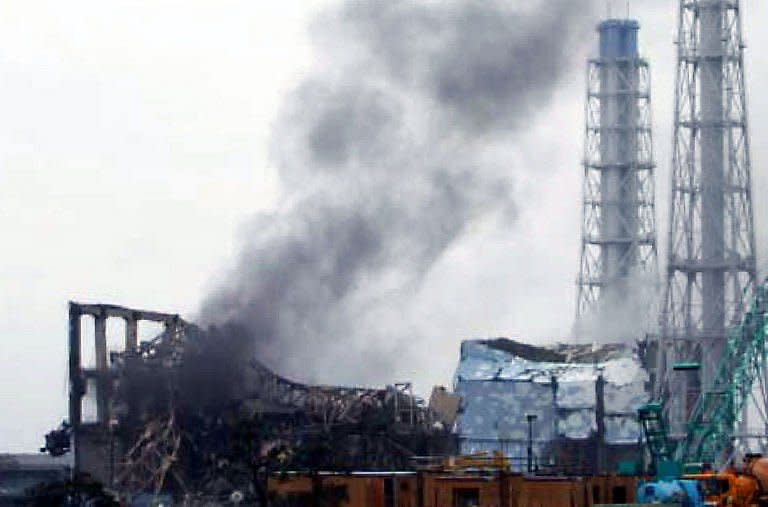 This handout picture released by Tokyo Electric Power Company (TEPCO) via Jiji Press shows black smoke rising from reactor number three of the number 1 Fukushima Dai-ichi nuclear power plant. Smoke belched from a stricken nuclear plant in Japan on Monday, disrupting urgent efforts to repair the cooling systems as Tokyo halted some food shipments owing to radiation worries