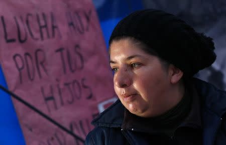 Enviromental activist Virginia Carpio stands next to a sign that reads "Fight for your kids Today" inside a tent set up to protest against Barrick Gold Corp's Veladero gold mine in Jachal, San Juan province, Argentina, April 27, 2017. REUTERS/Marcos Brindicci