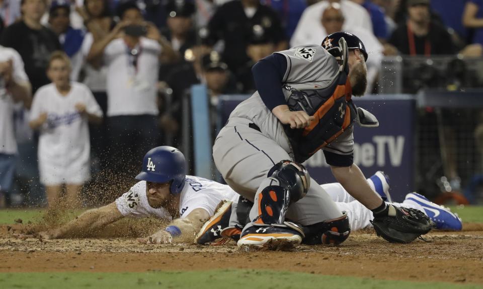 <p>Los Angeles Dodgers’ Logan Forsythe scores past Houston Astros catcher Brian McCann during the 10th inning of Game 2 of baseball’s World Series Wednesday, Oct. 25, 2017, in Los Angeles. Forsythe scored from second on a hit by Enrique Hernandez. (AP Photo/David J. Phillip) </p>