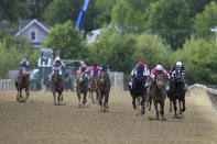 Flavien Prat atop Rombauer, second from right, leads the pack before winning the Preakness Stakes horse race at Pimlico Race Course, Saturday, May 15, 2021, in Baltimore. (AP Photo/Nick Wass)