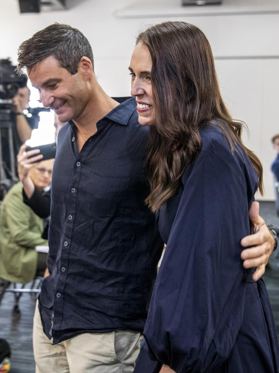 New Zealand Prime Minister Jacinda Ardern, right, hugs her fiancee Clark Gayford after announcing her resignation at a press conference in Napier, New Zealand, Thursday, Jan. 19, 2023. Fighting back tears, Ardern told reporters that Feb. 7 will be her last day in office. (Mark MItchell/New Zealand Herald via AP)