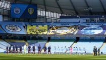 Players and match officials stand for two minutes silence prior to kick off to mark the passing of Prince Philip at the age of 99 during the English Premier League soccer match between Manchester City and Leeds United at Etihad Stadium, Manchester, England, Saturday April 10, 2021.(AP Photo/Tim Keeton,Pool)