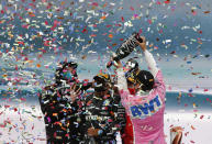Mercedes driver Lewis Hamilton of Britain, cwnter, is sprayed champagne at the podium on the podium of the Formula One Turkish Grand Prix at the Istanbul Park circuit racetrack in Istanbul, Sunday, Nov. 15, 2020. Racing Point driver Sergio Perez of Mexico, right, finished second and Ferrari driver Sebastian Vettel of Germany, finished third. (AP Photo/Kenan Asyali, Pool)