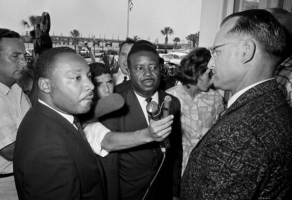 Motel manager James Brock, right, stops civil rights leaders Dr. Martin Luther King Jr., left, and Rev. Ralph Abernathy at the door of his motel restaurant when they tried to enter with a group to have lunch, June 12, 1964. The integrationists were arrested when they refused to leave the premises. The Associated Press