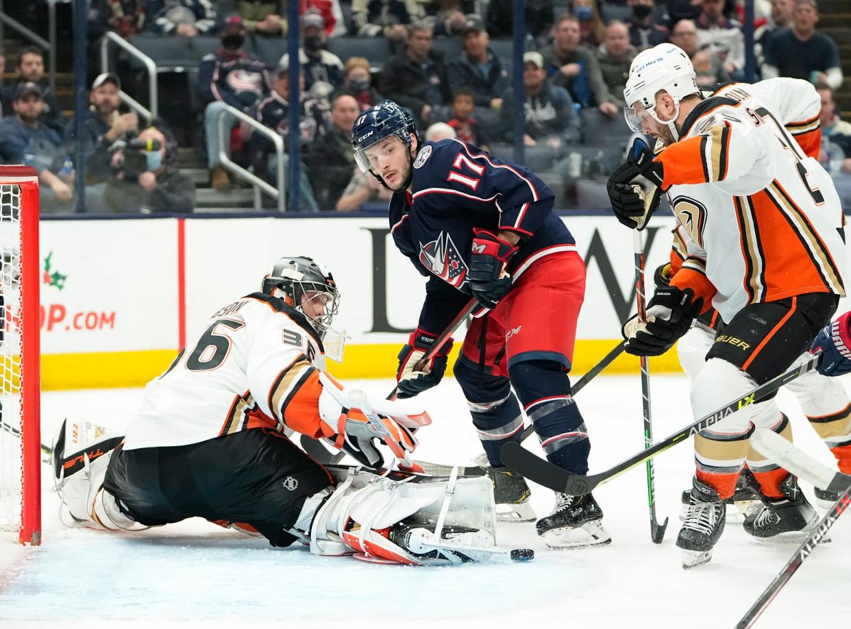 Anaheim Ducks goaltender John Gibson (36) makes a save in front of Columbus Blue Jackets right wing Justin Danforth (17) during the third period of the NHL hockey game at Nationwide Arena in Columbus on Thursday, Dec. 9, 2021.