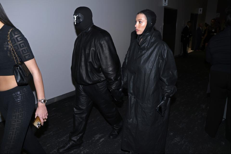 Kanye West, left and, Bianca Censori arrive during the NFL Super Bowl 58 football game Sunday, Feb. 11, 2024, in Las Vegas. (AP Photo/Mark Von Holden)