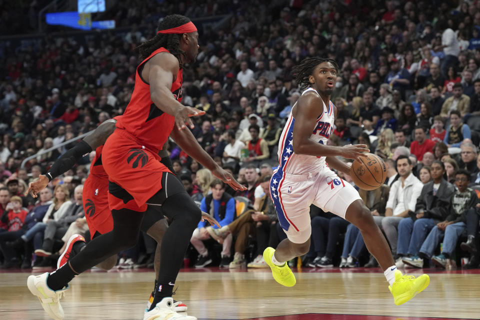 Philadelphia 76ers' Tyrese Maxey drives past Toronto Raptors' Precious Achiuwa during the second half of an NBA basketball game Saturday, Oct. 28, 2023, in Toronto. (Chris Young/The Canadian Press via AP)