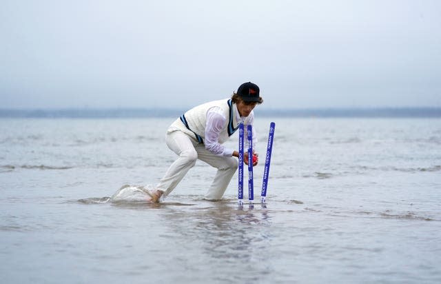 The wicket keeper breaks the stumps (Andrew Matthews/PA)