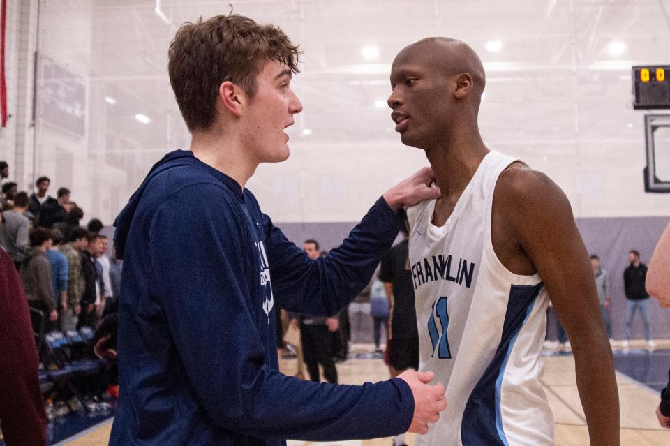 Franklin senior captain Sean O'Leary and senior Hansy Jacques talk after defeating BC High, 66-49, in the Division 1 Elite 8 game at Franklin High, March 9, 2024.