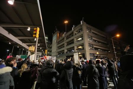 QUALITY REPEAT - Protesters gather outside Terminal 4 at JFK airport in opposition to U.S. president Donald Trump's proposed ban on immigration in Queens, New York City, U.S., January 28, 2017. REUTERS/Stephen Yang