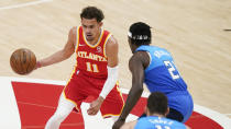Atlanta Hawks' Trae Young (11) dribbles against Milwaukee Bucks' Jrue Holiday (21) during the first half of Game 3 of the NBA Eastern Conference basketball finals Sunday, June 27, 2021, in Atlanta. (AP Photo/Brynn Anderson)