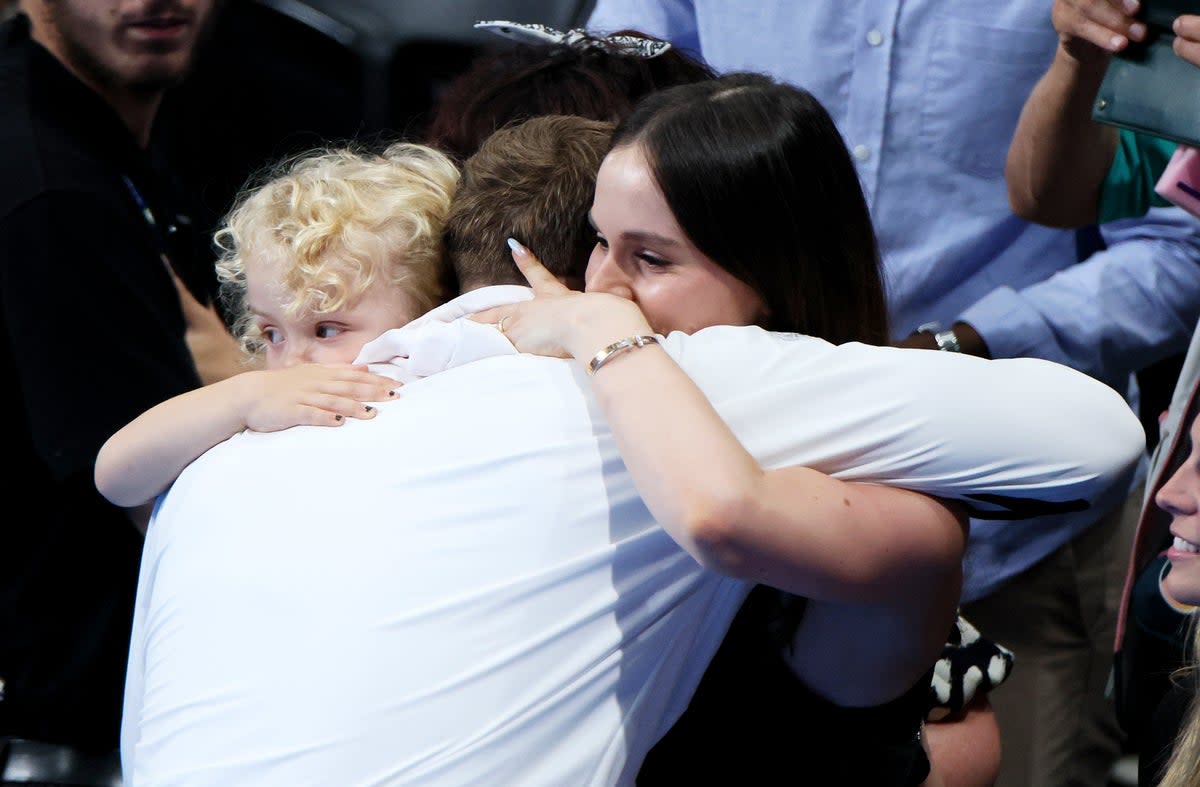 Adam Peaty celebrates with his child (from former partner Eiri Munro) and partner Holly Ramsay (Getty)