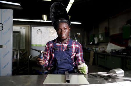 Yamoussa Sylla, 22, from Guinea, poses during his apprenticeship for a metal worker at 'WBG Blechverarbeitung GmbH' in Schwerte, Germany, October 5, 2015. REUTERS/Ina Fassbender