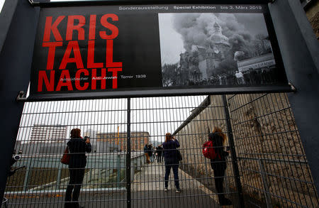 Visitors walk beside remains of the Berlin Wall at the Topography of Terror museum located at the site of the former Nazi Gestapo and SS headquarters, as Germany marks the 80th anniversary of Kristallnacht, also known as Night of Broken Glass in Berlin, Germany, November 9, 2018. REUTERS/Fabrizio Bensch