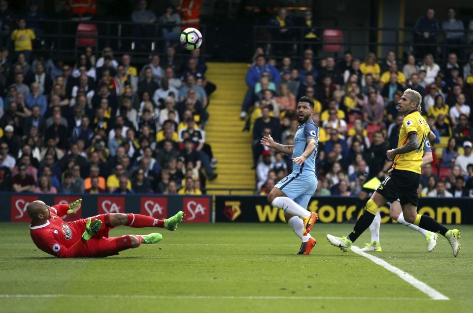 <p>Manchester City’s Sergio Aguero , centre right eyes the ball prior to his shot being saved by Watford keeper Heurelho Gomes, left, during the English Premier League soccer match between Manchester City and Watford, at Vicarage Road, in Watford, England. (Steven Paston/PA/ via AP) </p>