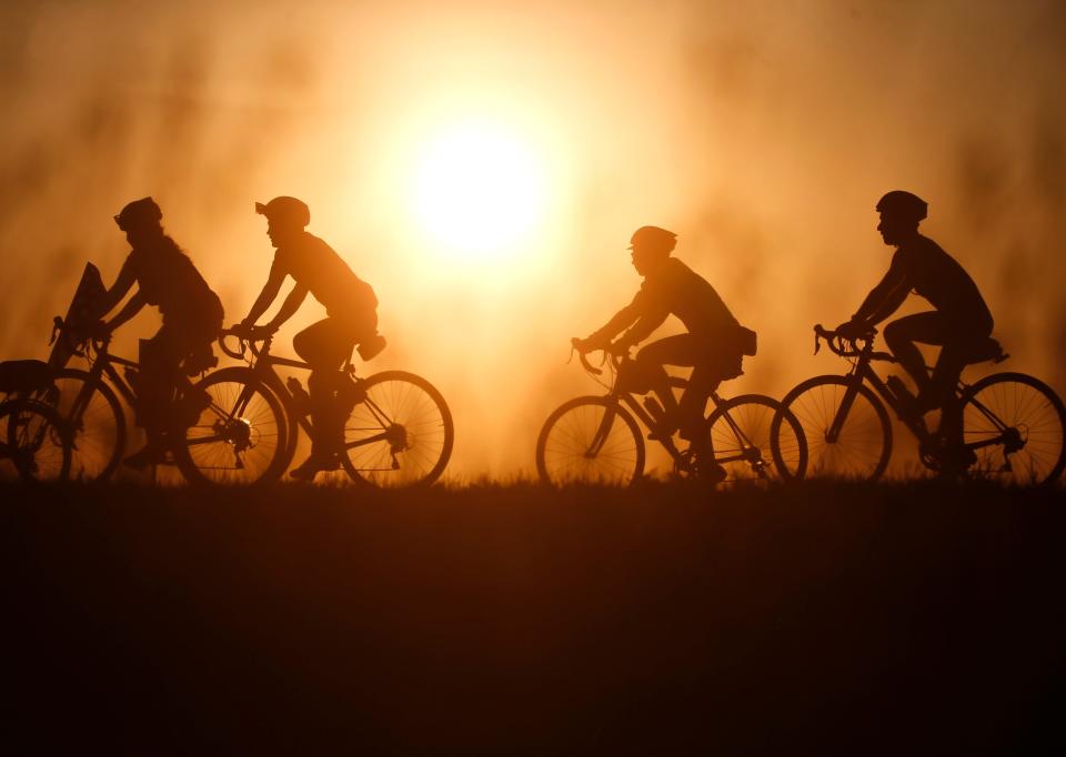 Cyclists roll out of Pocahontas early on Tuesday during RAGBRAI.