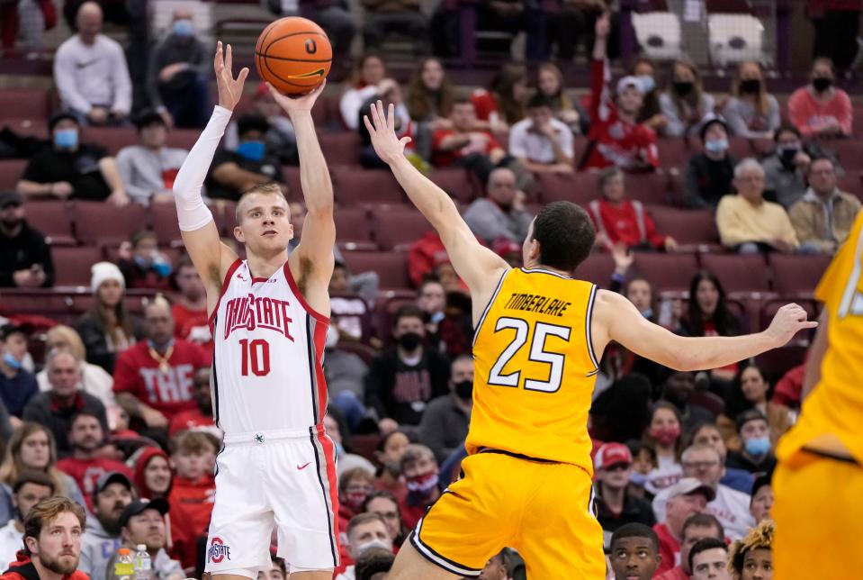 Ohio State Buckeyes forward Justin Ahrens (10) hits a three pointer over Towson Tigers guard Nicolas Timberlake (25) during the second half of the NCAA men's basketball game at Value City Arena in Columbus on Wednesday, Dec. 8, 2021.