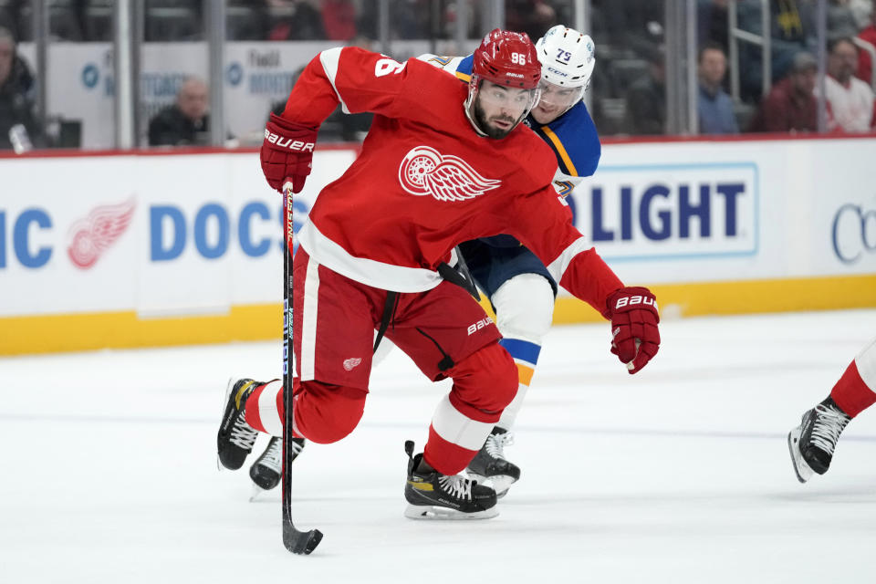 Detroit Red Wings defenseman Jake Walman (96) protects the puck from St. Louis Blues left wing Sammy Blais (79) in the first period of an NHL hockey game Thursday, March 23, 2023, in Detroit. (AP Photo/Paul Sancya)