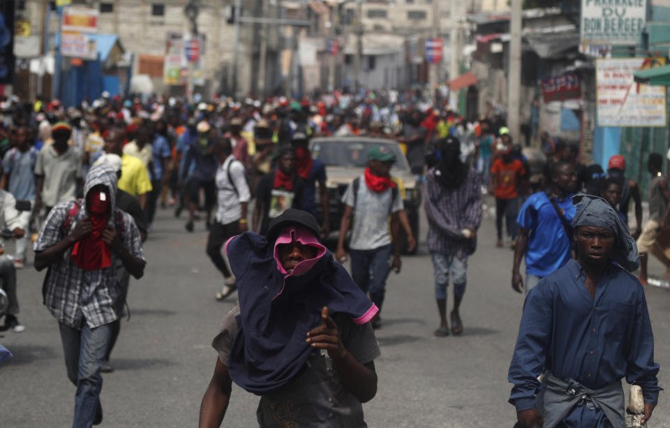 Protesters gather for a nationwide push to block streets and paralyze Haiti's economy as they press for President Jovenel Moise to give up power, in Port-au-Prince, Haiti, Monday, Sept. 30, 2019. Opposition leaders and supporters say they are angry about public corruption, spiraling inflation and a dwindling supply of gasoline that has forced many gas stations in the capital to close as suppliers demand the cash-strapped government pay them more than $100 million owed. (AP Photo/Rebecca Blackwell)