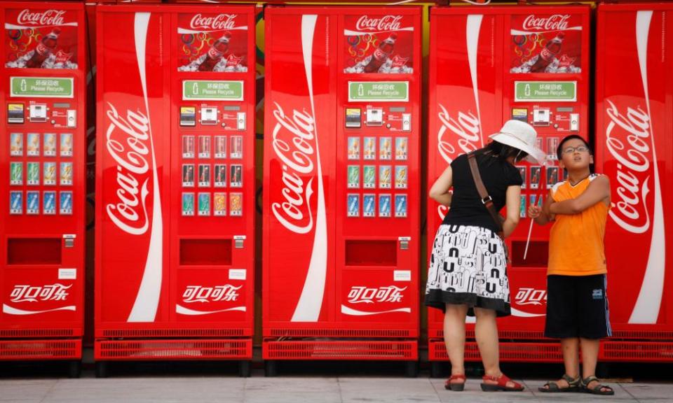 A woman and boy next to Coca-Cola machines in Beijing