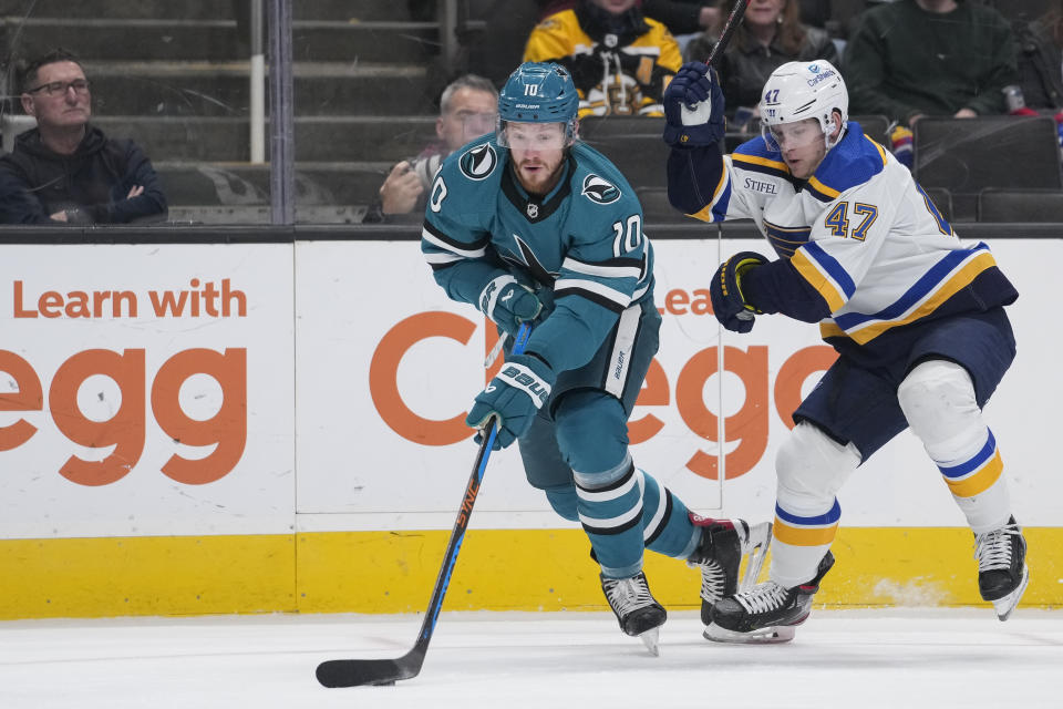 San Jose Sharks left wing Evgeny Svechnikov, left, moves the puck while defended by St. Louis Blues defenseman Torey Krug during the first period of an NHL hockey game in San Jose, Calif., Thursday, March 2, 2023. (AP Photo/Godofredo A. Vásquez)