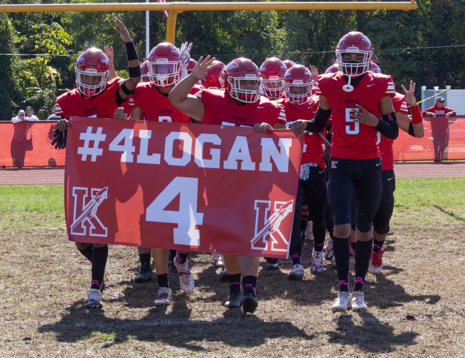 Keyport players carry ut banner to honor injured team mate Logan Blanks. Keyport football defeats Keansburg in Keyport, NJ on October 15, 2022.