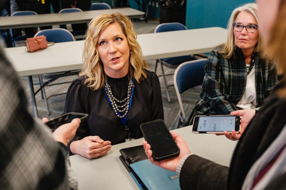 Natalie Bolon, executive director of the ADAMHS Board of Tuscarawas and Carroll counties, answers questions after a press conference, at the Tolloty Technology Incubator. Seated at right is Veronica Spidell, manager of community services for the ADAMH Board.