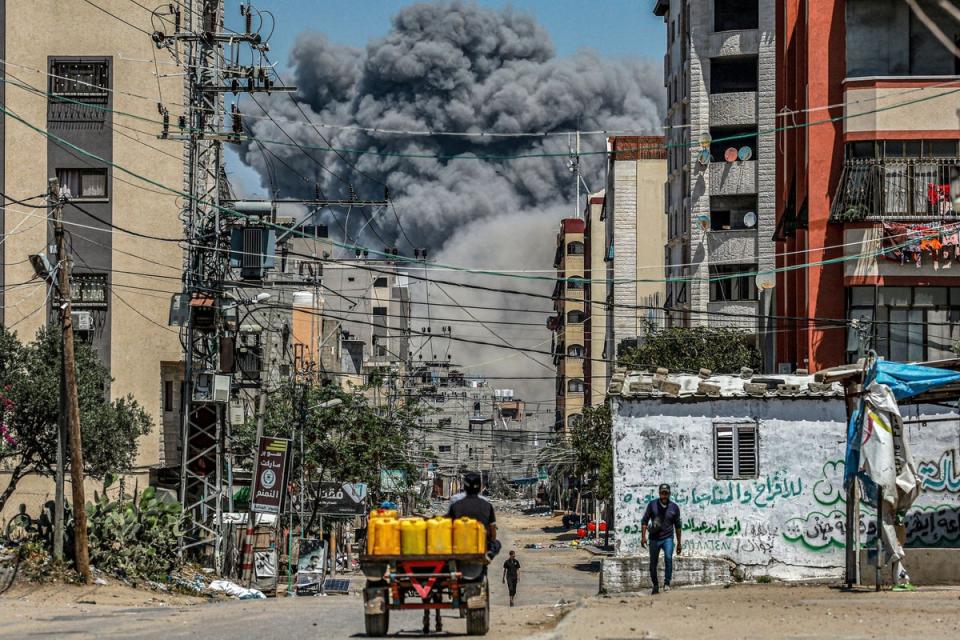 A cloud of smoke erupts after an Israeli airstrike in Nuseirat in the central Gaza Strip (AFP via Getty Images)