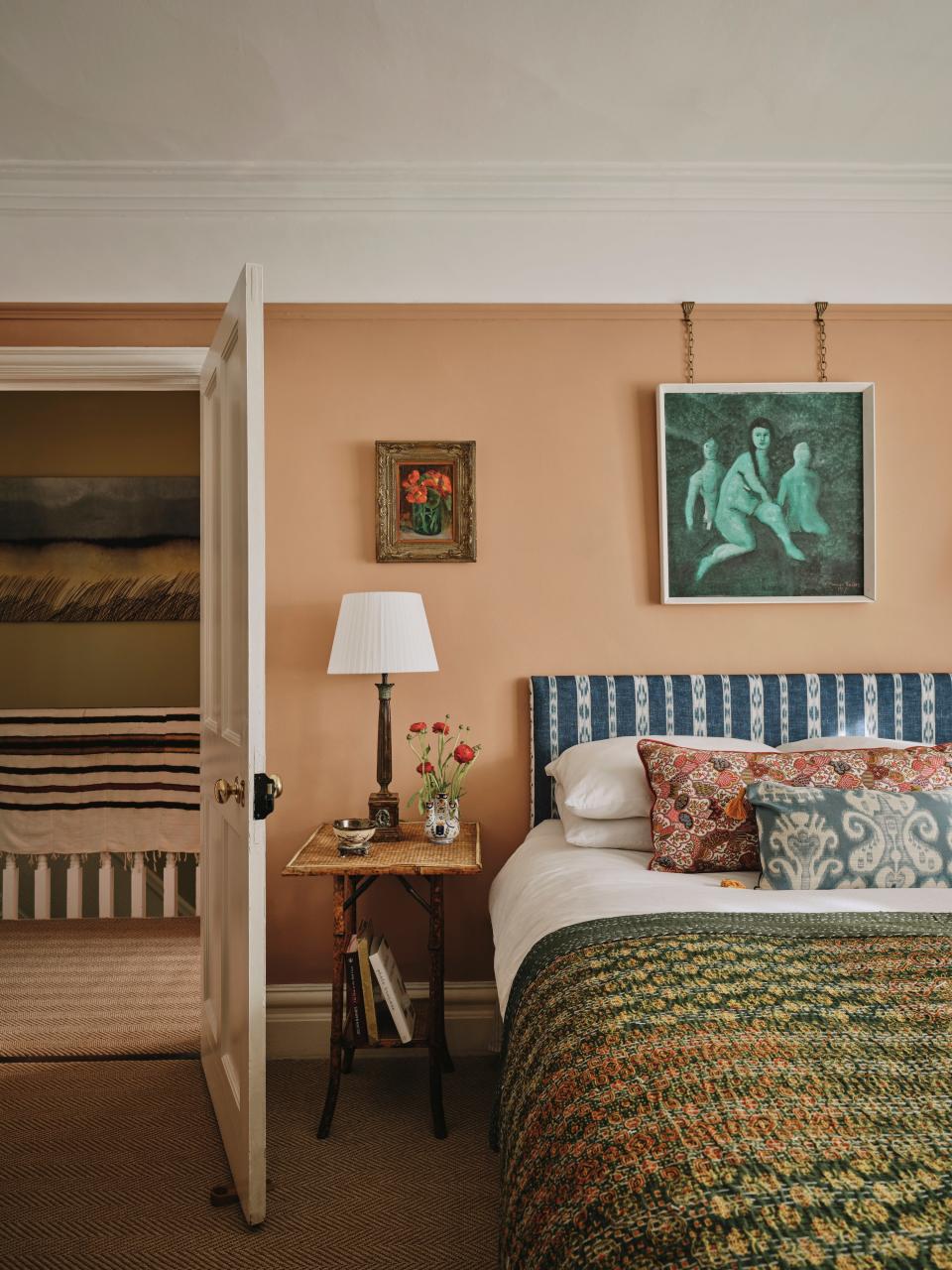 James set his mind to making the guest bedroom the coziest space possible. “I wanted people staying with us to feel like I did when I visited my grandparents as a child,” he reflects. He chose the wall color for its slightly ’90s edge and admits it took him a really long time to find. The bedside table, lamp, and painting are all vintage.