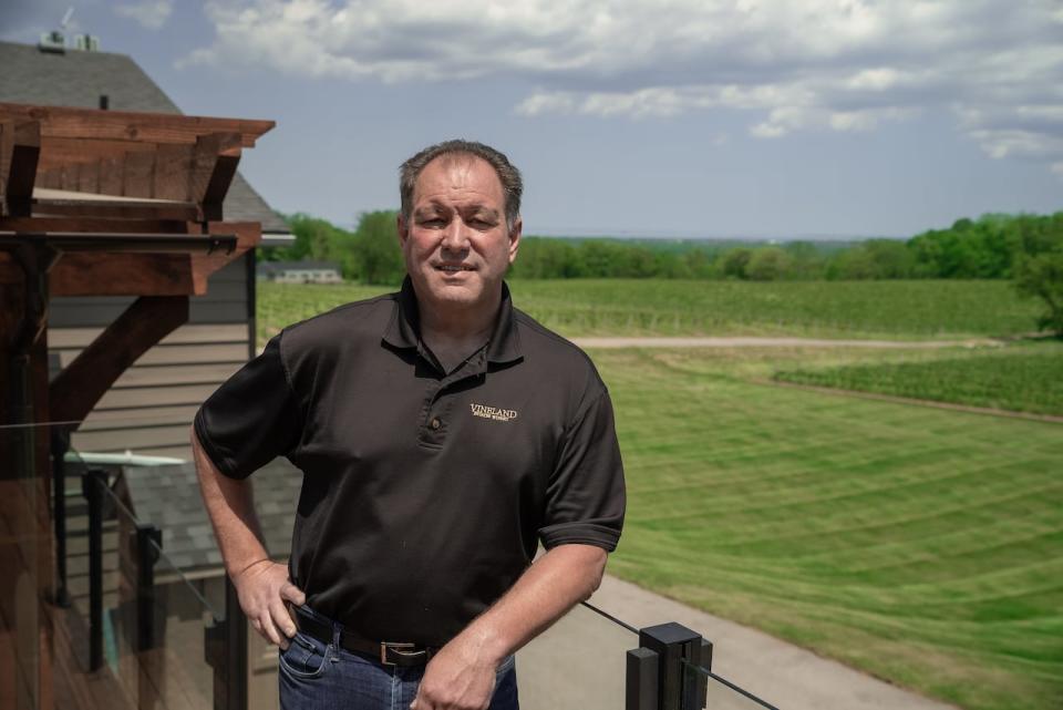 Allan Schmidt, president of Vineland Estates, leans on the balcony overlooking acres of vineyards. May 23, 2024. 