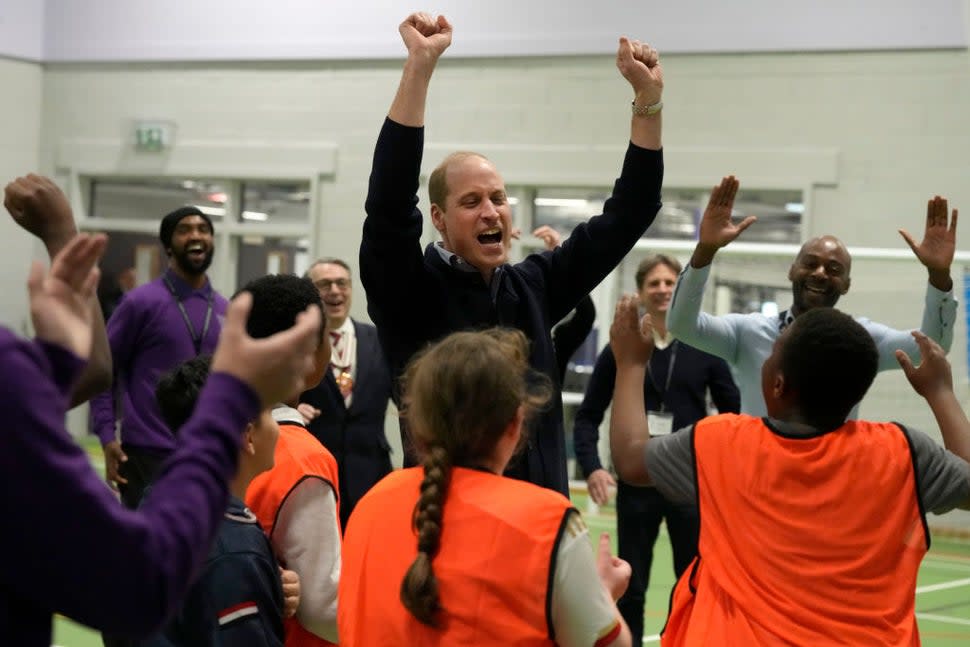  Prince William, Prince Of Wales celebrates with young people after he threw a basketball during his visit to WEST, a new OnSide Youth Zone WEST on March 14, 2024 in London, England