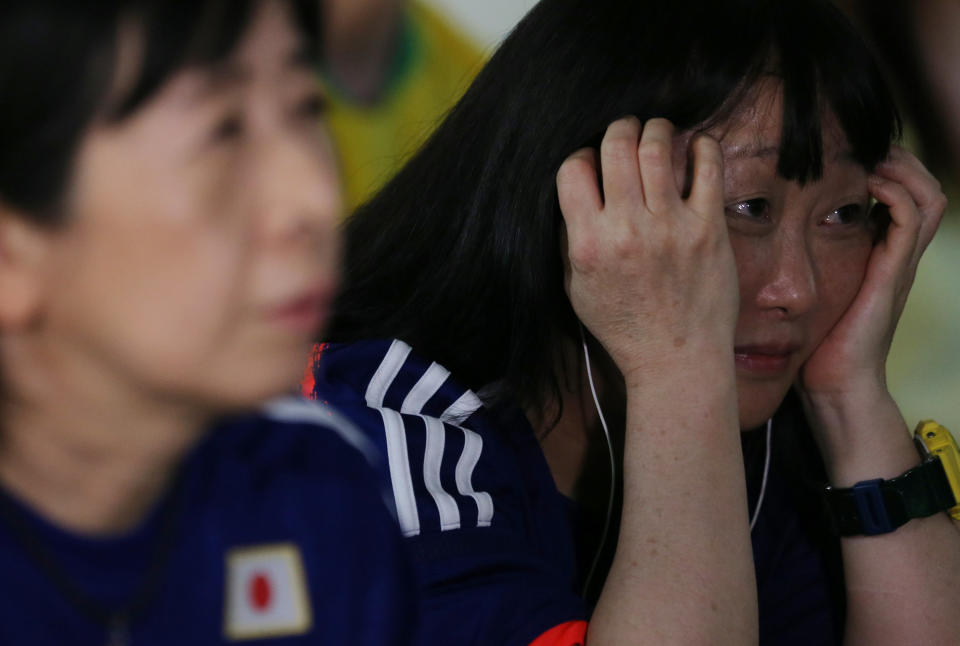 <p>Japanese descendants react during the broadcast of the FIFA World Cup soccer match. REUTERS/Paulo Whitaker </p>