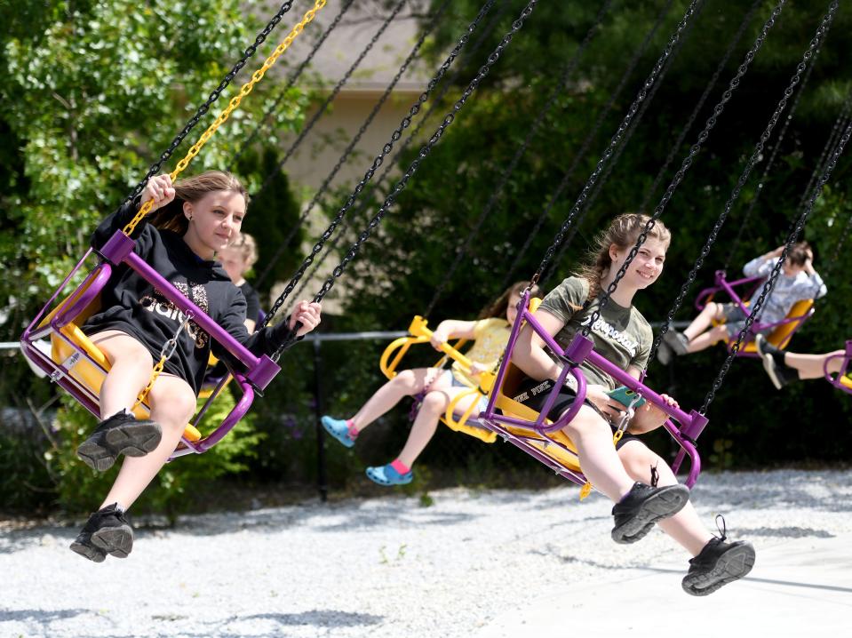 Rilley Bailey, left, and Cyleeana McCartney fly through the air as Massillon City School fifth grade students take an end of the year field trip to Sluggers & Putters Amusement Park in Canal Fulton.
