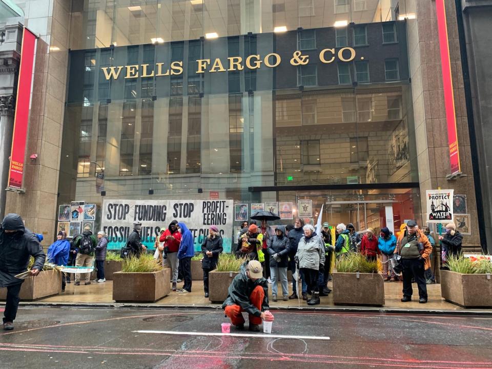 people gathered in front of wells fargo and co glass facade