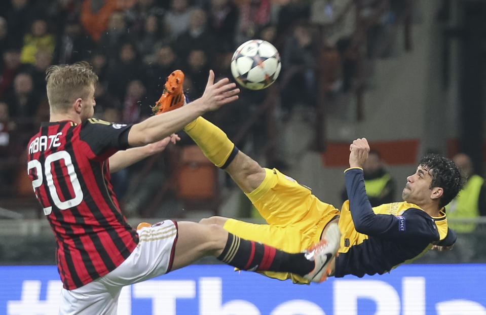 Atletico Madrid Brazilian forward Diego Costa, right, tries an acrobatic shot as AC Milan defender Ignazio Abate tries to stop him during a Champions League, round of 16, first leg, soccer match between AC Milan and Atletico Madrid at the San Siro stadium in Milan, Italy, Wednesday, Feb. 19, 2014. (AP Photo/Antonio Calanni)