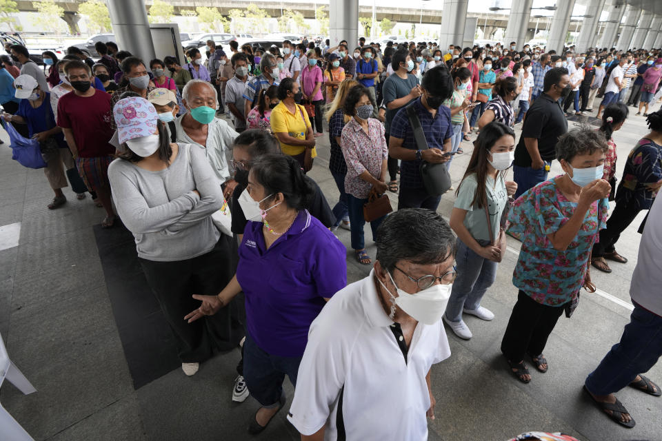 Residents wait on line to receive shots of the AstraZeneca COVID-19 vaccine at the Central Vaccination Center in Bangkok, Thailand, Thursday, July 22, 2021. (AP Photo/Sakchai Lalit)