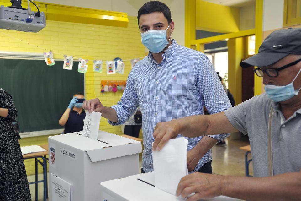 Davor Bernardic, leader of the Restart coalition casts his ballot at a polling station in Zagreb, Croatia, Sunday, July 5, 2020. Amid a spike of new coronavirus cases, voters in Croatia cast ballots on Sunday in what is expected be a close parliamentary race that could push the latest European Union member state further to the right. (AP Photo)