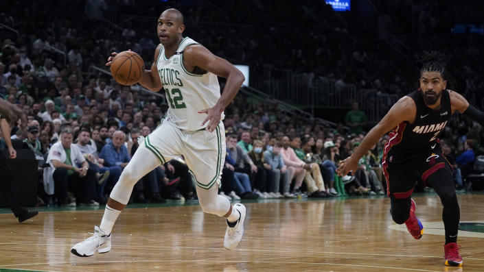 Boston Celtics center Al Horford (42) drives past Miami Heat guard Gabe Vincent (2) during the second half of Game 4 of the NBA basketball playoffs Eastern Conference finals, Monday, May 23, 2022, in Boston. (AP Photo/Charles Krupa)