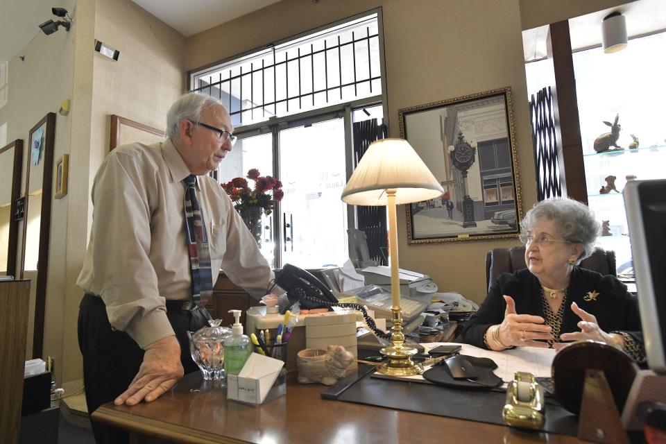 Roy Thomas talks with his wife Delorise at her desk in the showroom of Jacobs Jewelers on Thursday. In 1987 the couple bought the business. With the recent new ownership of the historic Greenleaf Building, they will be moving the jewelry story to a new location in January.
