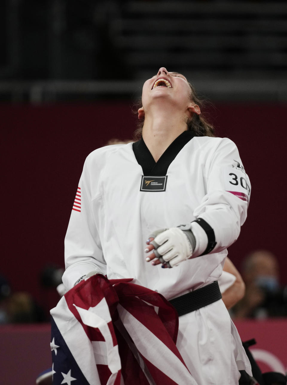 United States's Anastasija Zolotic celebrates as she holds her country national flag after winning the gold medal for the taekwondo women's 57kg at the 2020 Summer Olympics, Sunday, July 25, 2021, in Tokyo, Japan. (AP Photo/Themba Hadebe)