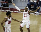 Oklahoma guards De'Vion Harmon (11) and Elijah Harkless (24) react during the second half of an NCAA college basketball game against Kansas in Norman, Okla., Saturday, Jan. 23, 2021. (AP Photo/Garett Fisbeck)