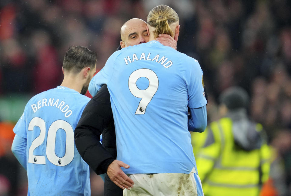 Manchester City's head coach Pep Guardiola hugs Erling Haaland after the English Premier League soccer match between Liverpool and Manchester City, at Anfield stadium in Liverpool, England, Sunday, March 10, 2024. The match ended 1-1. (AP Photo/Jon Super)