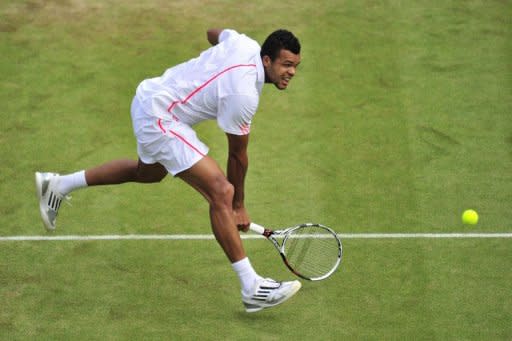 France's Jo-Wilfried Tsonga plays a shot during his men's singles quarter-final victory over Germany's Philipp Kohlschreiber on day nine of the 2012 Wimbledon Championships tennis tournament at the All England Tennis Club in Wimbledon, southwest London. Tsonga won the match