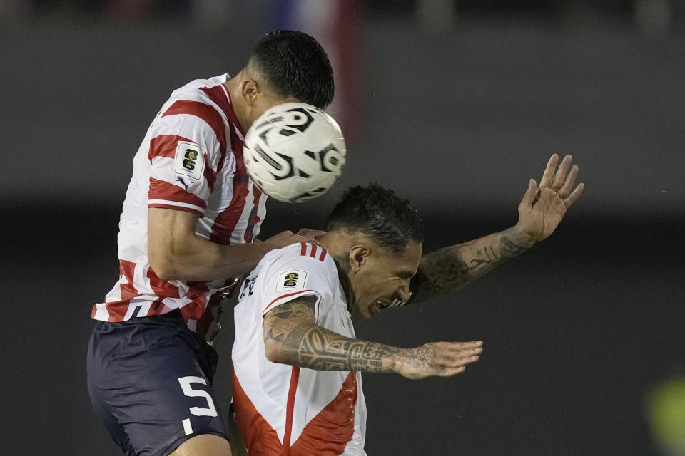 Paraguay's Fabian Balbuena, left, heads the ball over Peru's Paolo Guerrero during a qualifying soccer match for the FIFA World Cup 2026, at Antonio Aranda stadium in Ciudad del Este, Paraguay, Thursday, Sept. 7, 2023. (AP Photo/Jorge Saenz)