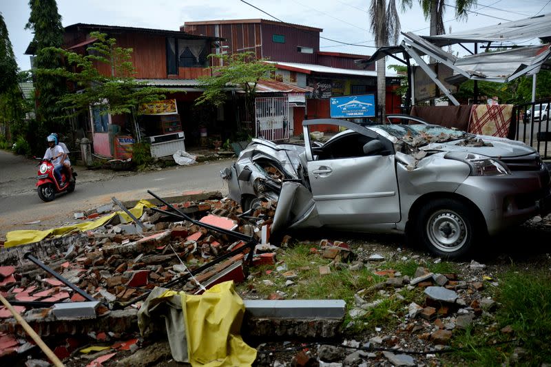 A damaged car is seen among the ruins following an earthquake in Mamuju