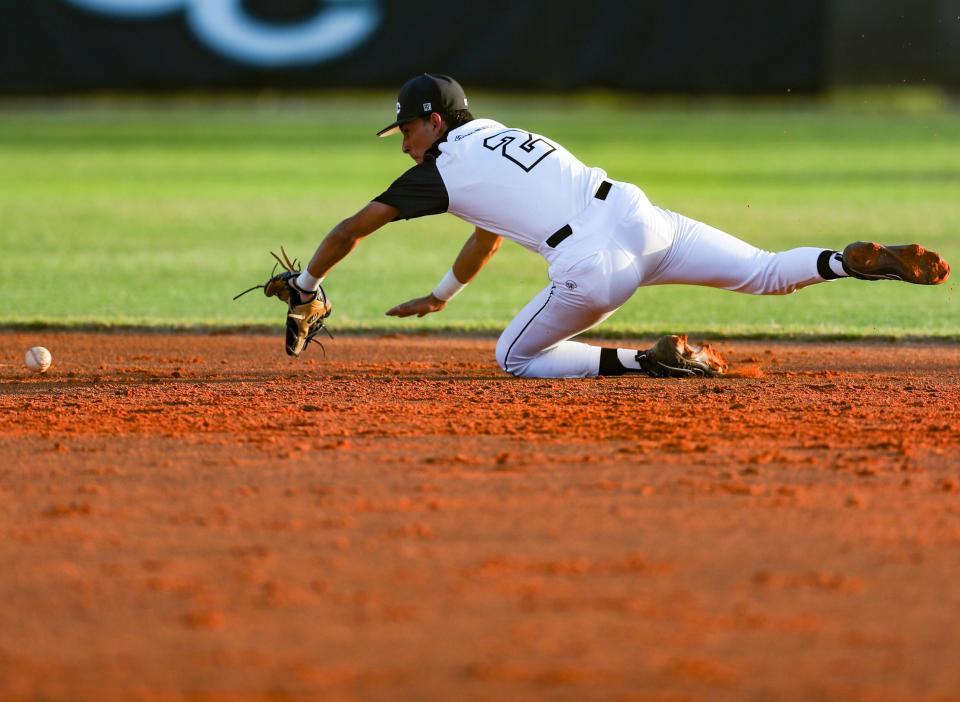 The Sharks' Vincent Mattei dives for a ball. The Canterbury Cougars compete against the Gulf Coast Sharks in a game at Gulf Coast High School in Naples on Tuesday, April 2, 2024.