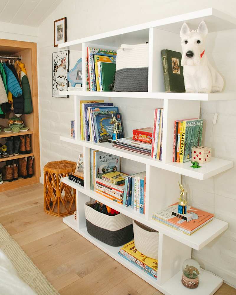 detail of white large shelves with books and toys